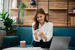 © laddawan - Confident beautiful Asian businesswoman typing laptop computer and digital tablet on sofa at office