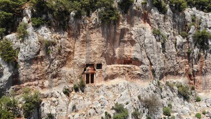 Wall Mural - Rock-cut tomb carved in vertical rock. Cyaneae, town of ancient Lycia, Antalya Province, Turkey. 