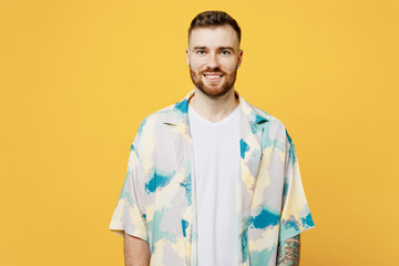 Wall Mural - Young smiling positive handsome cheerful caucasian happy fun man he wear blue shirt white t-shirt casual clothes looking camera isolated on plain yellow background studio portrait. Lifestyle concept.