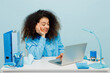 Young dissatisfied displeased sad employee IT business woman wear casual shirt sit work at white office desk with pc laptop prop up head isolated on plain pastel light blue background studio portrait.
