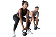 Fit and muscular couple focused on lifting a dumbbell during an exercise class on a transparent background