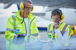 Air traffic control ground crew workers clipboard talking on airport tarmac