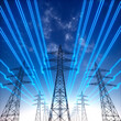 © peterschreiber.media - High voltage transmission towers with blue glowing wires against blue sky - Green energy concept