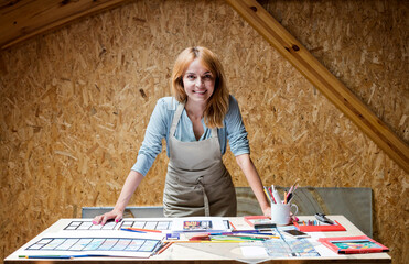 Wall Mural - Portrait smiling stained glass artist working in studio