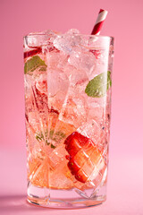 Wall Mural - Fresh healthy limonate cocktail with crushed ice, strawberry and mint on pinkbackground. Summer cold drink concept, close up shot