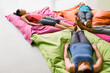 Women laying on cushions in restorative yoga gym studio