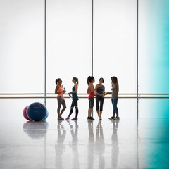 Wall Mural - Women talking and drinking water at barre in exercise class gym studio