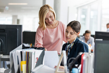 Poster - Businesswomen discussing paperwork in office