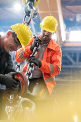 Wall Mural - Steel workers with crane hook in factory