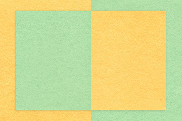 Texture of light green and yellow paper background with geometric shape and pattern, macro. Craft olive cardboard