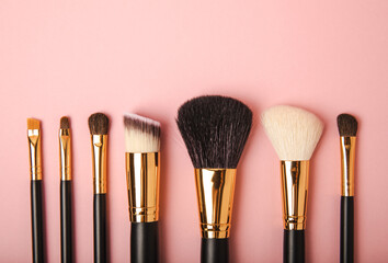 Sticker - Cosmetic makeup brush on a pink background. Cosmetic product for make-up. Creative and beauty fashion concept. Fashion. Collection of cosmetic makeup brushes, top view, banner.Place for text. MOCAP.