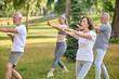 © zinkevych - A group of people practicing yoga in a park