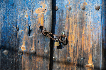 Wall Mural - Wooden door of an old stone house in the traditional village of Monodendri in Zagori, Greece