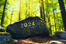 New Year Design 2024 Written On The Stone In The Forest Created With Generative Ai