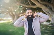 © Connect Images - Smiling young man relaxing in park