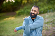 © Connect Images - Smiling young man stretching in park