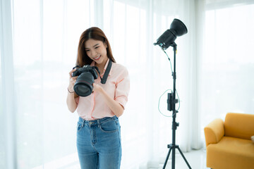 Wall Mural - Beautiful asian woman Vlogger and blogger recording video for social media content live streaming at home.