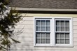 double-hung windows on house with eavestrough and roof line
