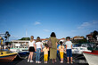 © AS Photo Family - Rear view of a group of children with mother standing on the deck of a yacht and looking at the sea.
