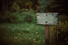 A Blank Wooden Sign Sitting In The Middle Of A Lush Green Field Next To A Forest Filled With Tall Grass