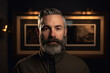 © ADDICTIVE STOCK - Generative AI image of bearded adult male with warm jacket looking at camera while standing in dark room with photo frame on wall with blurred lights