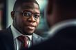 © ADDICTIVE STOCK - Generative AI illustration of smiling young African American male entrepreneur while standing and talking to unrecognizable colleague