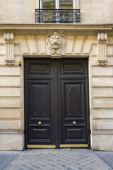 Wall Mural - Paris, an old wooden door, with a lion carved on the lintel, typical building in the 8e arrondissement
