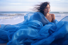 Fashion Model Woman With Blowing Blue Dress Posing On The Beach, Outdoors. Generative Ai Fashion Photorealistic Illustration