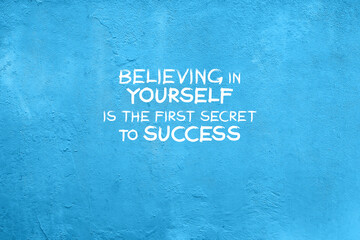 Wall Mural - Blue concrete wall with inspirational quotes - Believing in yourself is the first secret to success