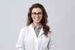 Portrait of beautiful young female doctor in white coat and glasses smiling at camera.