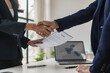 © ArLawKa - Job interview. Two businessmen shake hands to submit resume documents. HR manager shakes hands congratulating job candidates for successful job application close up pictures