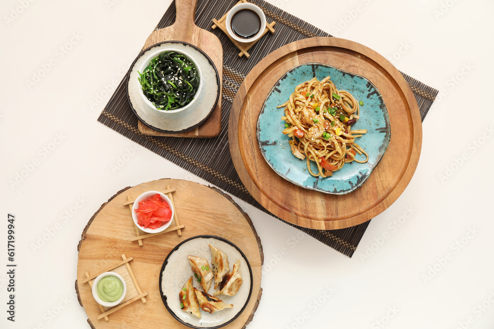 Composition with tasty Chinese food on light background