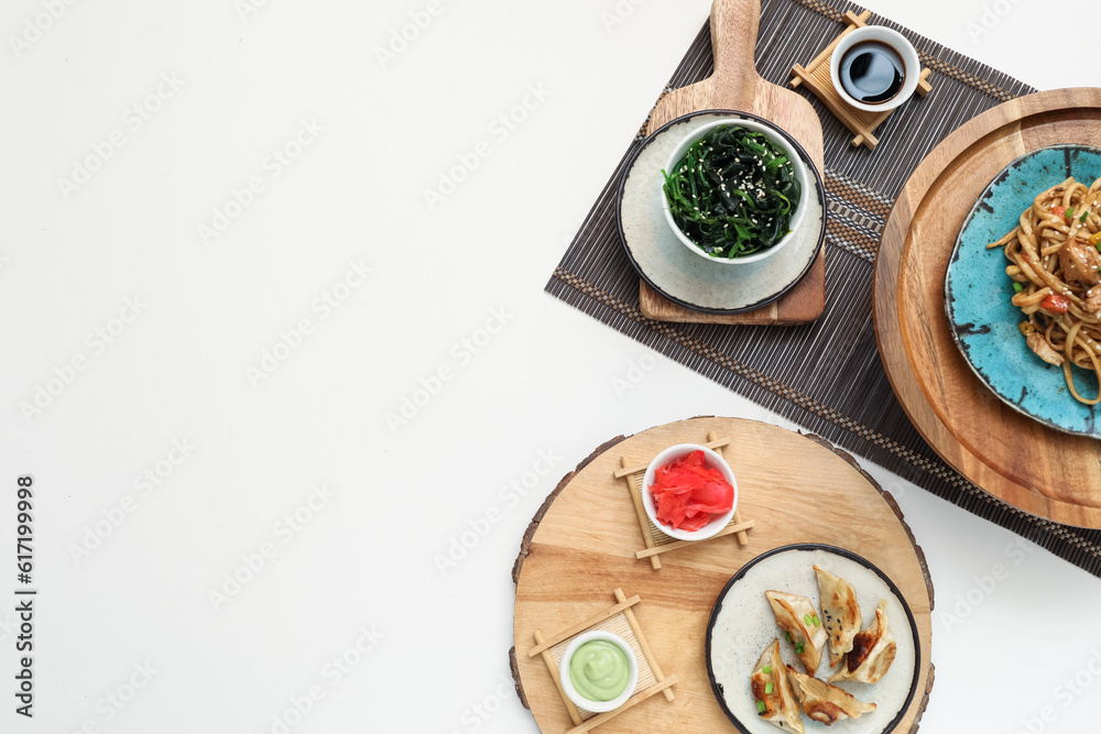 Composition with tasty Chinese food on light background