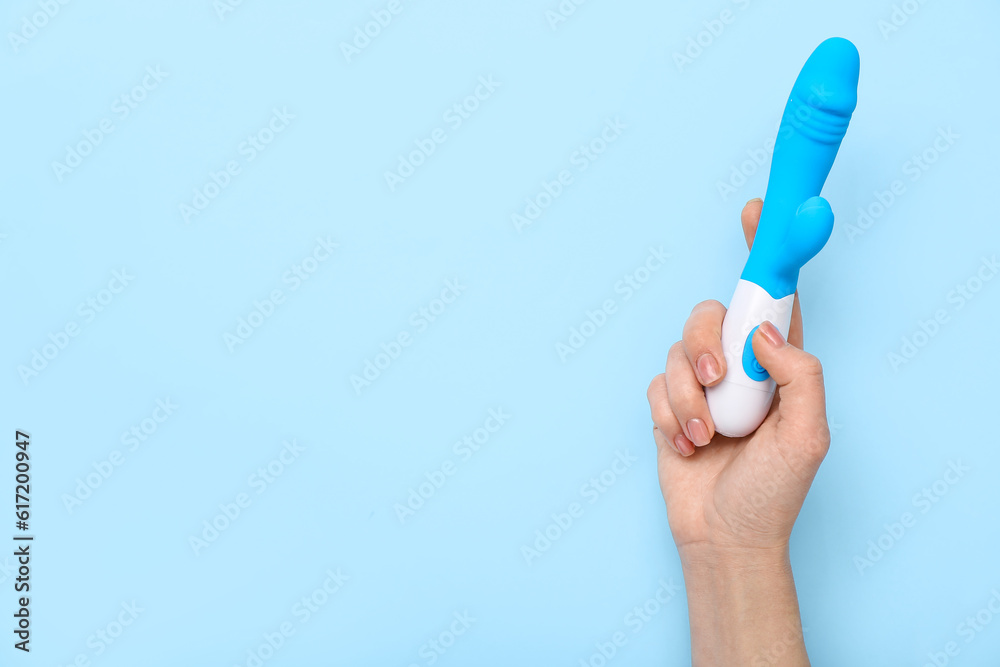 Woman with vibrator on blue background