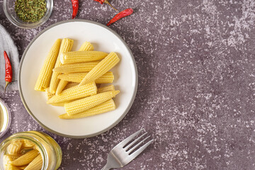 Canvas Print - Plate with canned baby corn cobs on grey grunge background