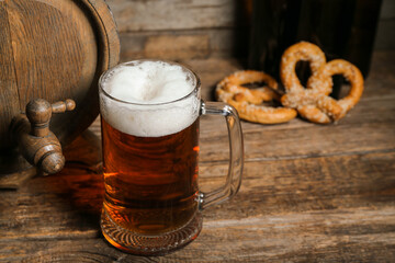 Mug of cold beer on wooden background. Oktoberfest celebration