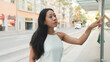 © Andrii Nekrasov - Close-up of pretty girl standing at public transport stop, analyzing the schedule of transport on the information board, chooses route