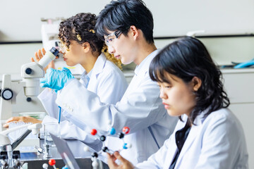 Poster - Multinational researcher group experimenting in the lab.
