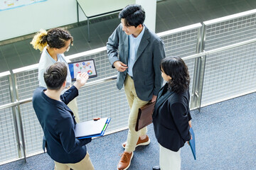 Poster - Multinational business group talking in lobby. Global business. High angle view.