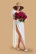 © Pixel-Shot - Beautiful young woman with bouquet of peony flowers on beige background