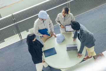 Poster - Group of multinational engineers and business people meeting in a building. International business. High angle view.