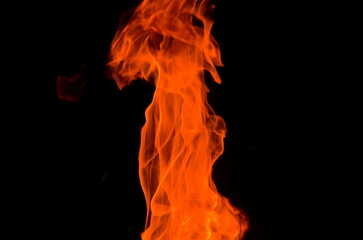 Poster - Bright orange thin flame on a dark background.