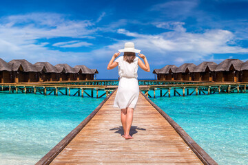 Canvas Print - Woman standing on the wooden pier