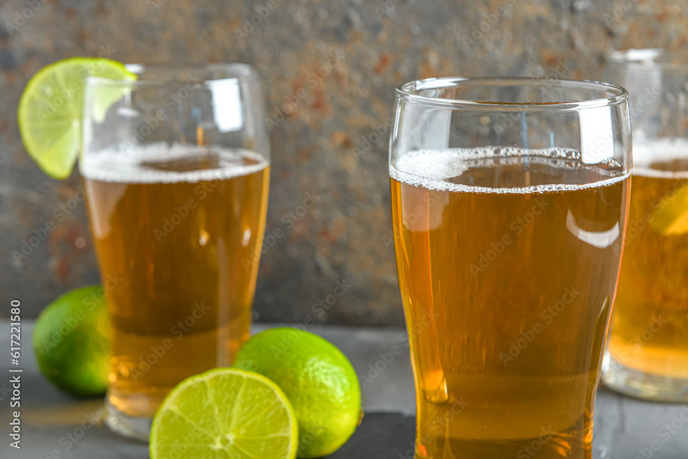 Glasses of cold beer with lime on table