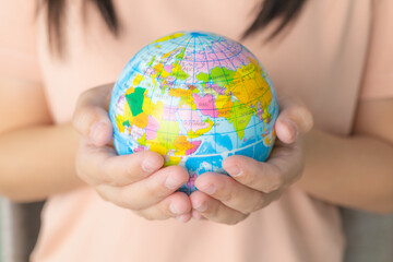 close up woman's hand holding a globe. earth in human hand. world environment and earth day. save th