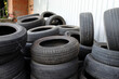 Stockpile of old used car tires. Variety of the protector patterns.