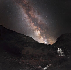 Wall Mural - soft focus. lots of small stars all over the frame. milky way over a mountain waterfall.
