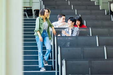 Poster - Group of multinational students having a conversation in a classroom.