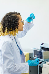 Poster - Female scientist looking at a test tube. Research and Development.