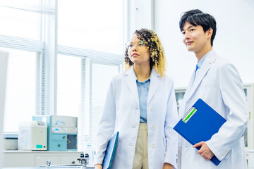Poster - Group of multinational people wearing white robe in classroom.